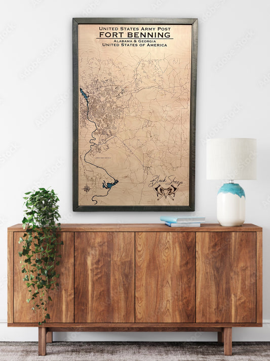 Large custom wooden military map of Fort Benning hanging on wall above a dresser.
