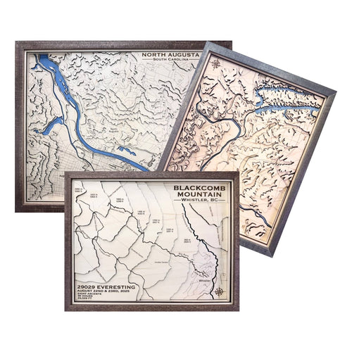 Three topographic maps of different locations with wooden frames on a white background.