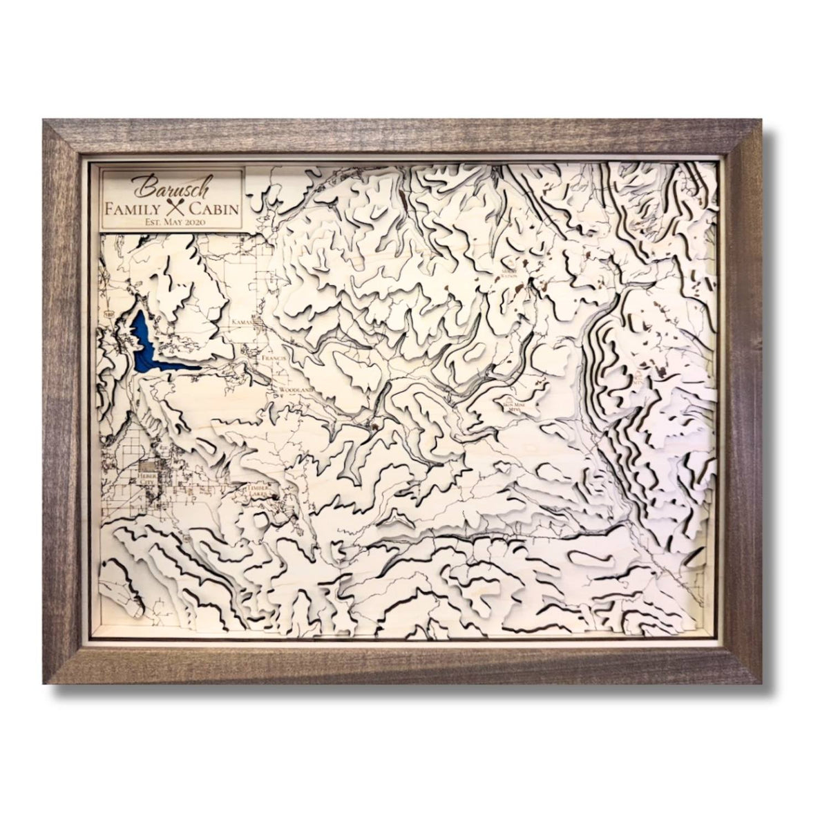 Custom wooden topographic map with personalized text.
