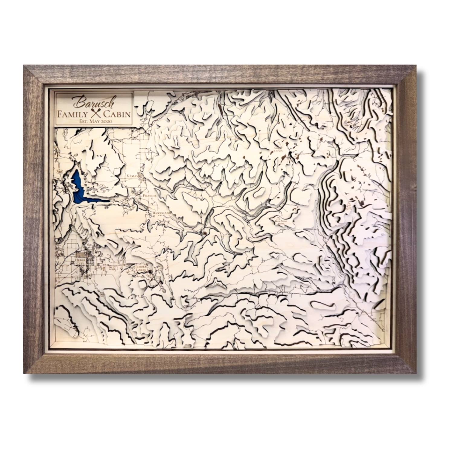 Custom wooden topographic map with personalized text.