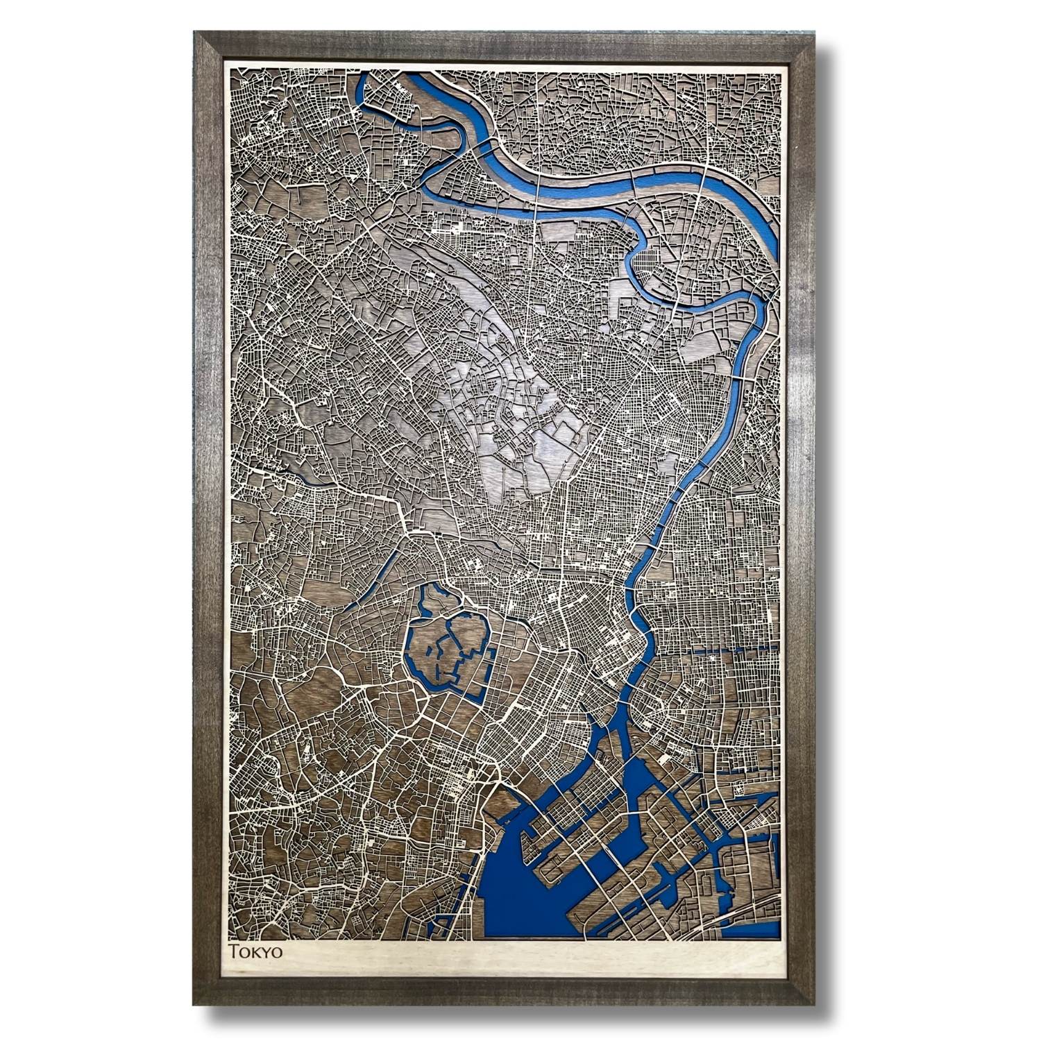 Framed wooden map of Tokyo with raised roads and recessed water layer. 