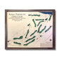 Framed map of Royal Portrush Golf Club with brown wooden frame, dark blue water stain, and raised green greens.