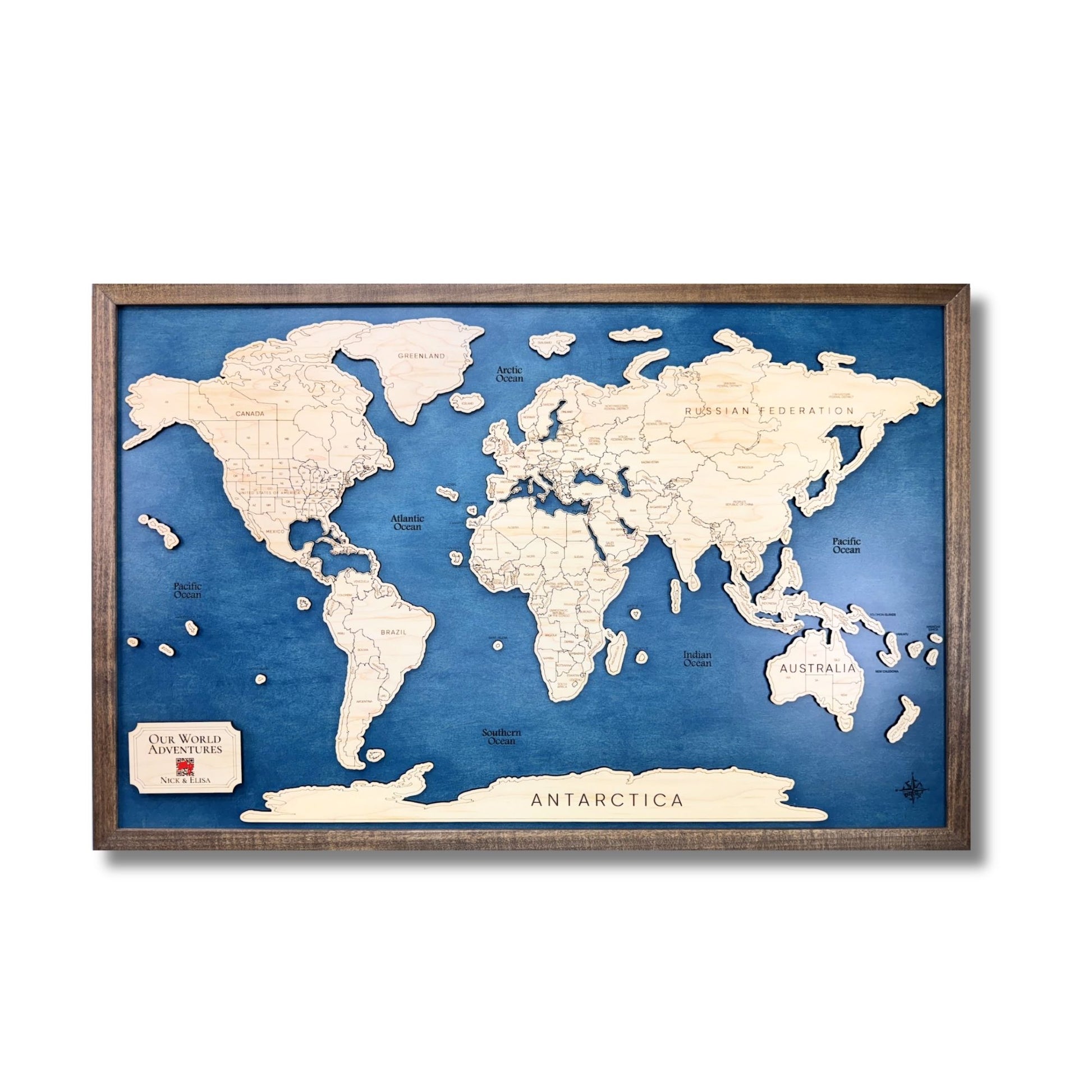 Wooden world travel map with a brown frame on a white background.