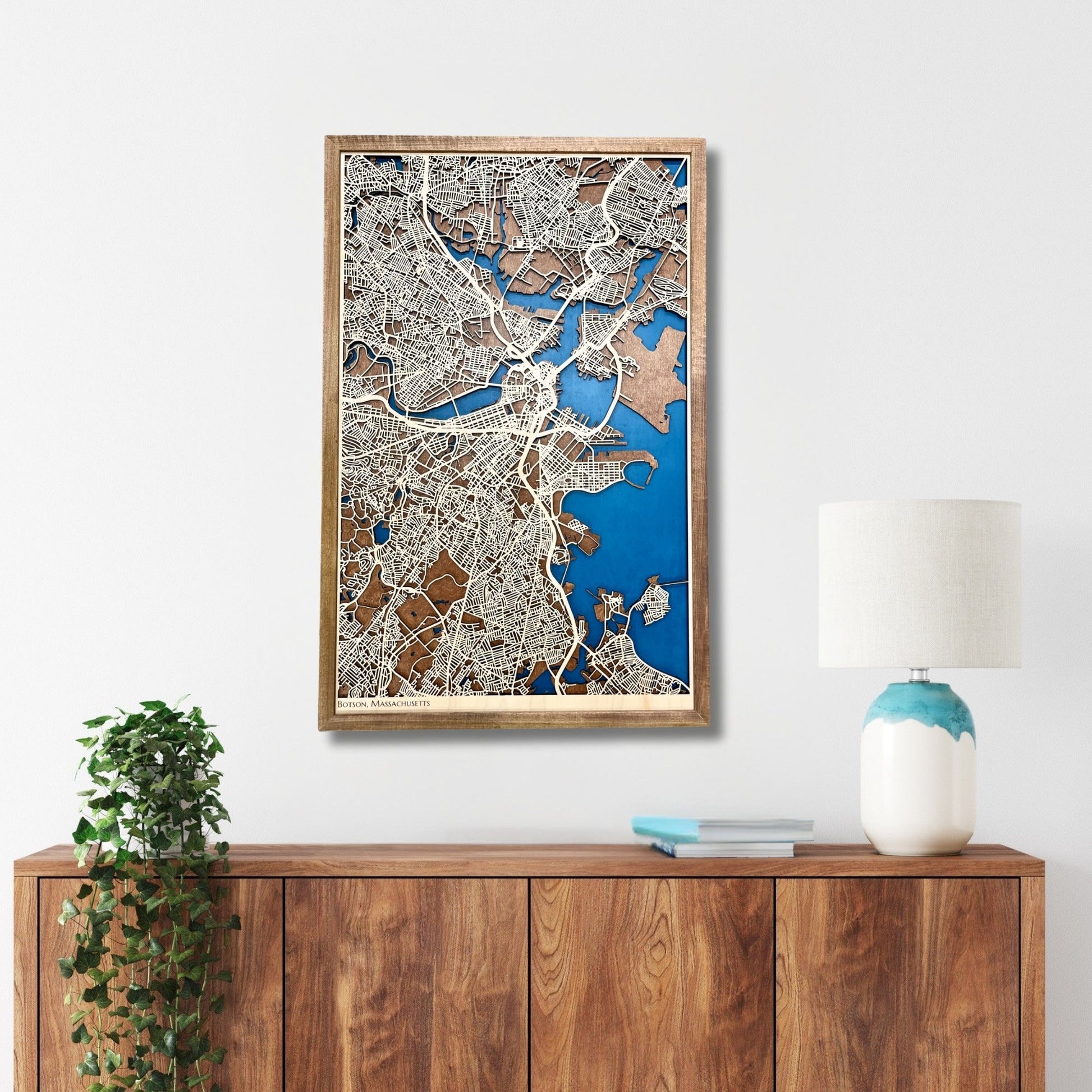 3D map of Boston, MA, hanging on a wall above a console. 