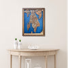 Framed wooden map of Bristol, RI hanging on wall above a wooden table with decorative items. 
