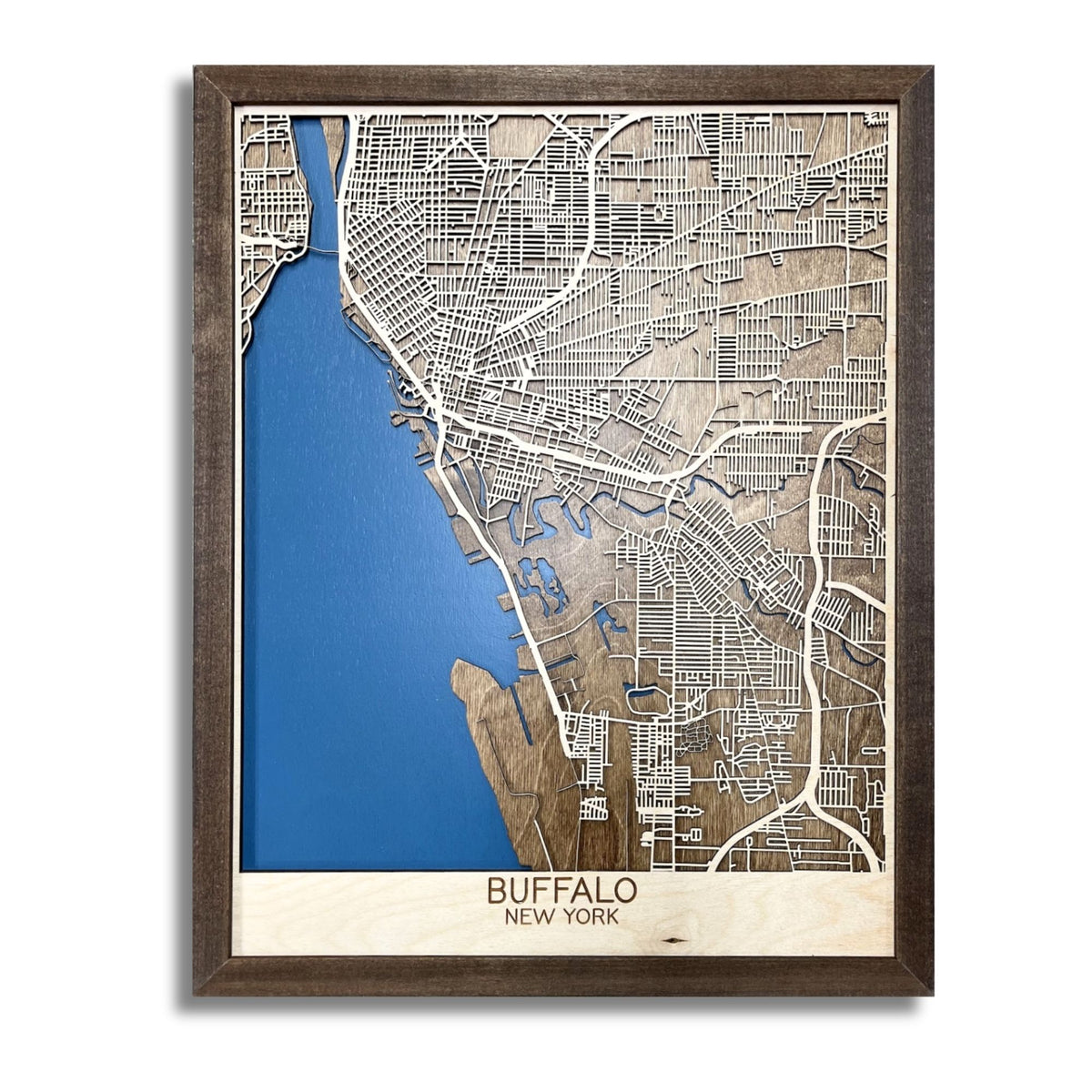 Framed wooden map of Buffalo, NY with dark blue water stain and raised roads. 