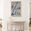 Framed wooden map of Manhattan hanging on a wall above a table. 