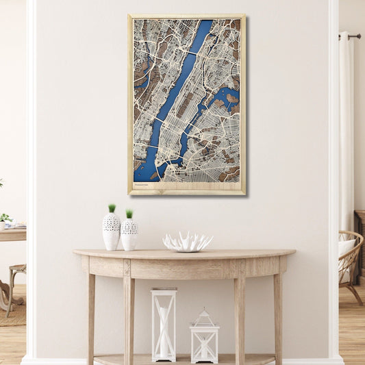 Framed wooden map of Manhattan hanging on a wall above a table. 