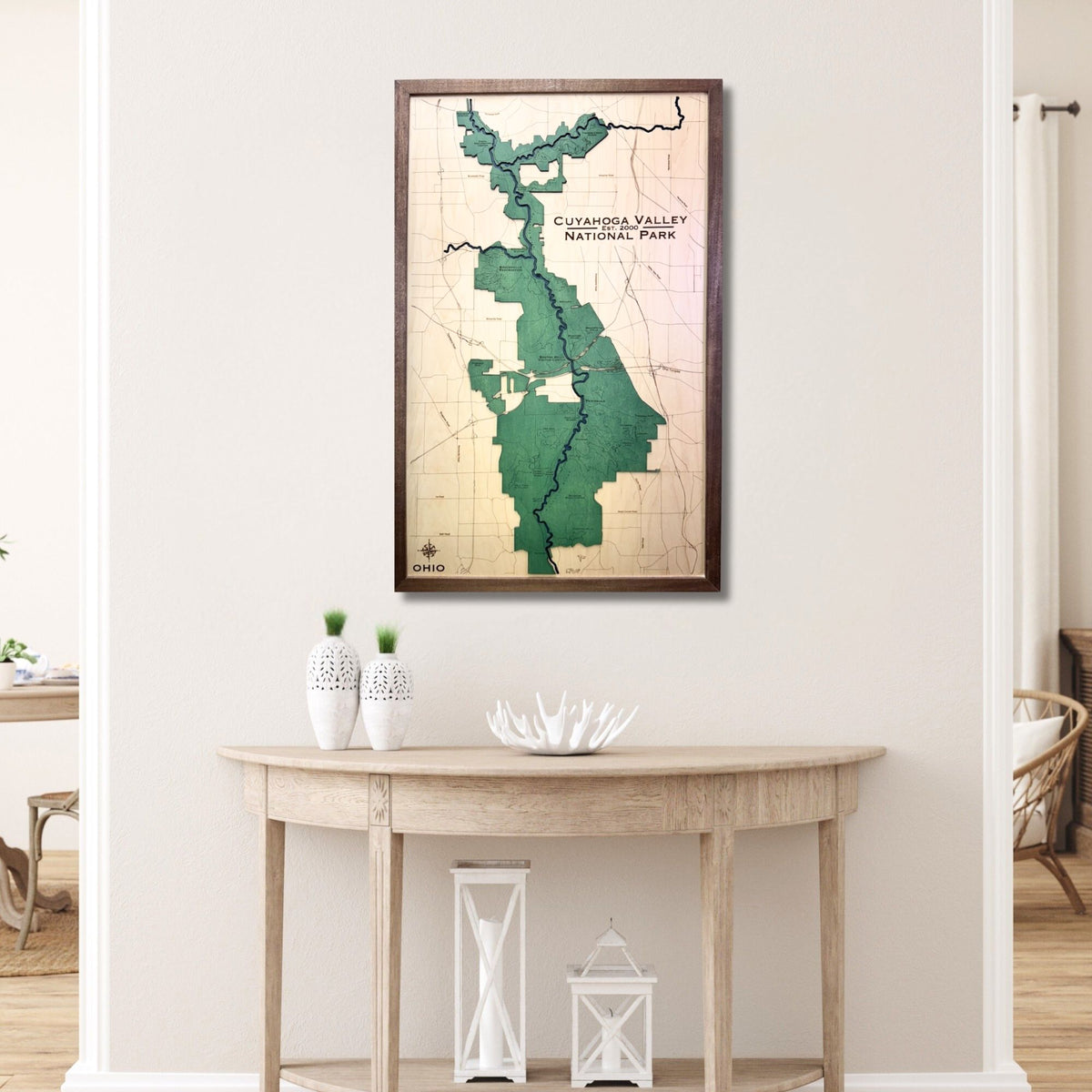 Framed map of Cuyahoga Valley National Park on a wall above a wooden table.