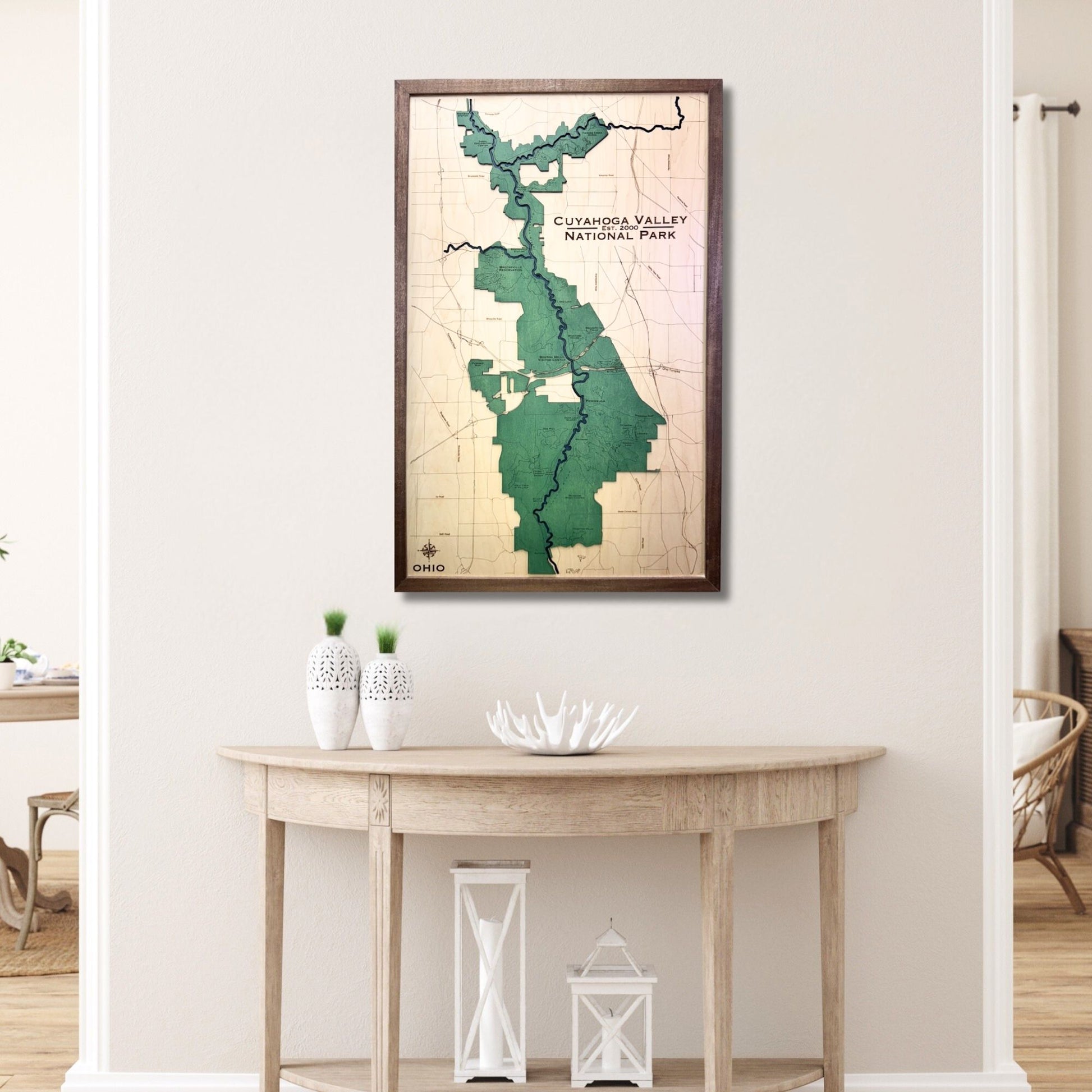 Framed map of Cuyahoga Valley National Park on a wall above a wooden table.