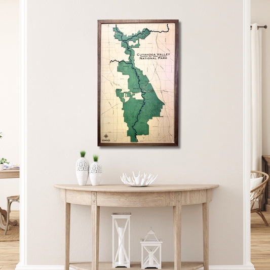 Framed map of Cuyahoga Valley National Park on a wall above a wooden table.