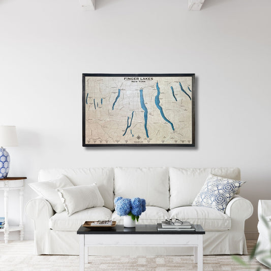 Wooden Finger Lakes map hanging on the wall of a living room above a couch. 