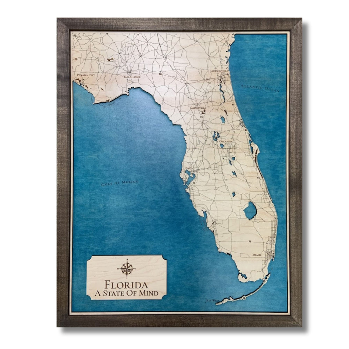 Framed wooden map of Florida and surrounding bodies of water.