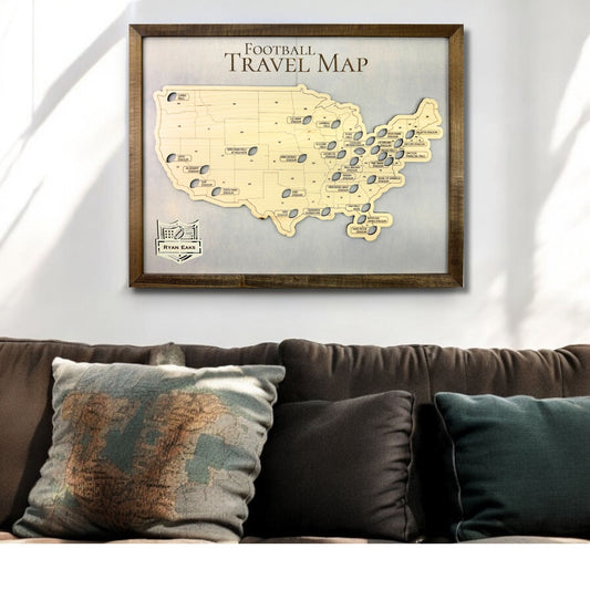 Wooden football stadium travel map hanging on a wall above a couch. 
