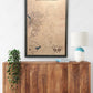 Large custom wooden military map of Fort Benning hanging on wall above a dresser. 