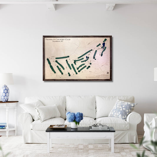 Living room with a white sofa, coffee table, and framed golf map on the wall.