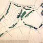 Close up of wooden golf course map with green fairways, blue water hazards, and engraved text. 
