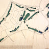 Close up of wooden golf course map with green fairways, blue water hazards, and engraved text. 