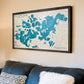 Custom wooden map of Lake Minnetonka hanging on wall above a couch. 