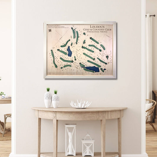 Framed map of Loudoun Golf & Country Club on a wall above a wooden table.