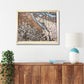 Framed Portland city map on a wall above a wooden cabinet with a plant and lamp.