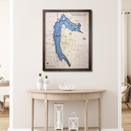 3D wood map of Pymatuning Lake hanging on a wall over a table. 