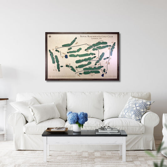 Living room with a white sofa, coffee table, and framed golf course map on the wall.