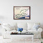 Living room with a white sofa, coffee table, and framed golf map on the wall.