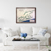 Living room with a white sofa, coffee table, and framed golf map on the wall.