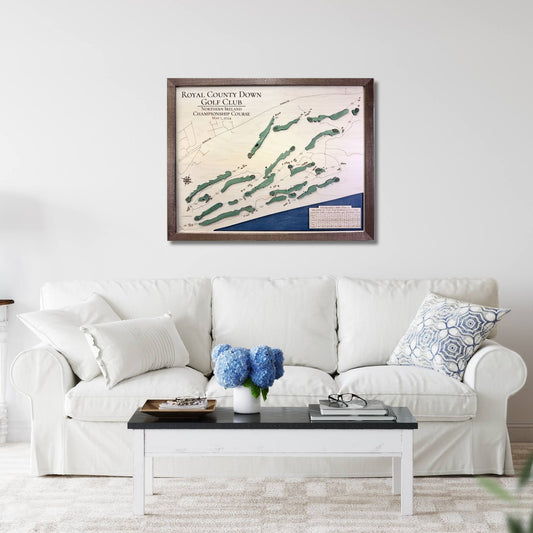 Living room with a white sofa, coffee table, and framed golf map on the wall.