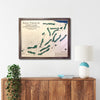 Framed map of Royal Portrush Golf Club on a wall above a wooden cabinet.
