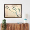 Framed wooden map of Stillwater Golf & Country Club on a wall above a wooden console table.