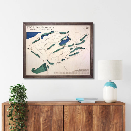 Framed wooden map of TPC River Highlands golf course on a wall above a wooden console table.