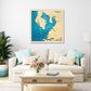 Framed wooden map of Tampa Bay on a wall above a living room sofa with decorative pillows.