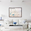 Framed wooden topographic map on a wall above a white sofa in a living room.