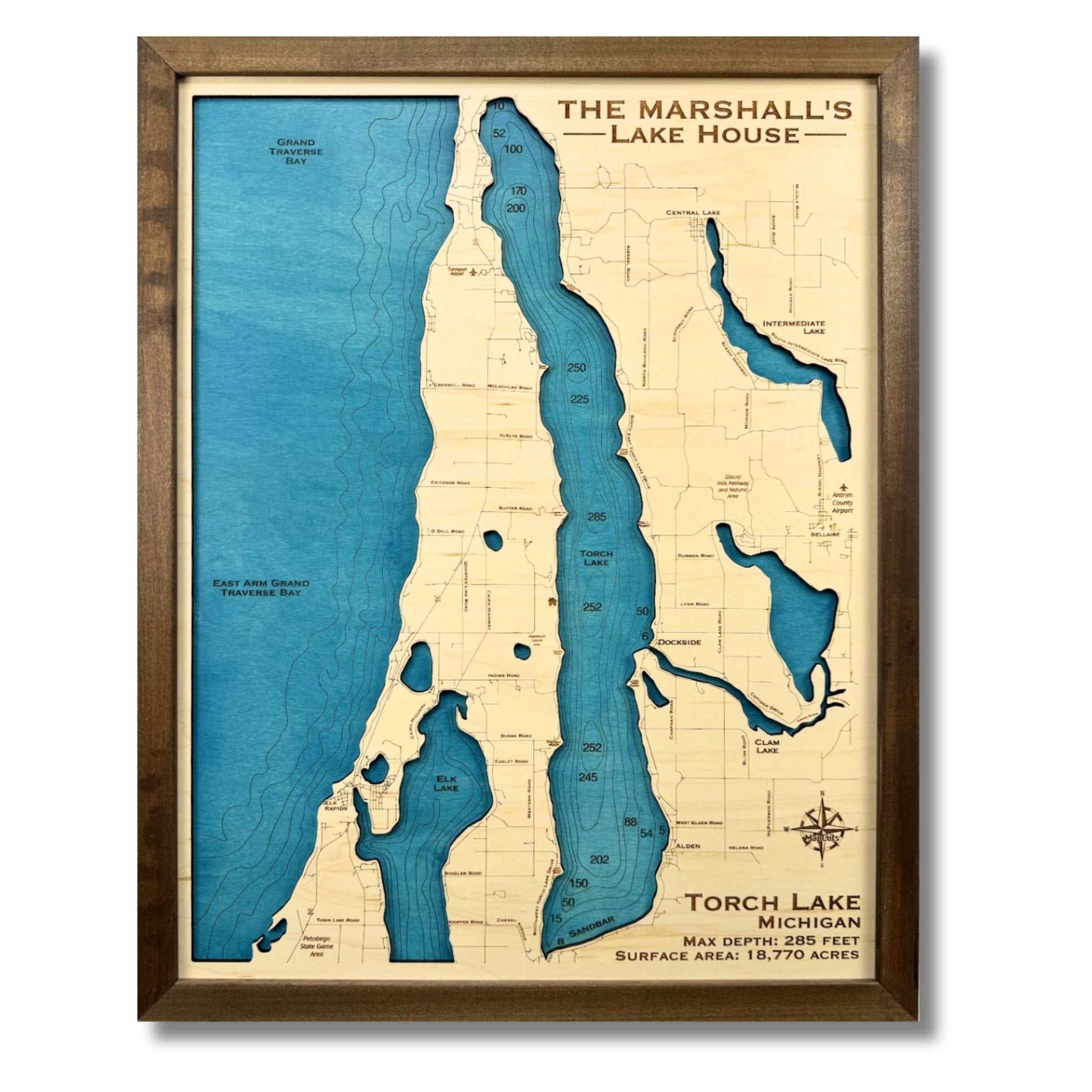 Wooden Torch Lake map with engraved water layers and a walnut brown frame. 