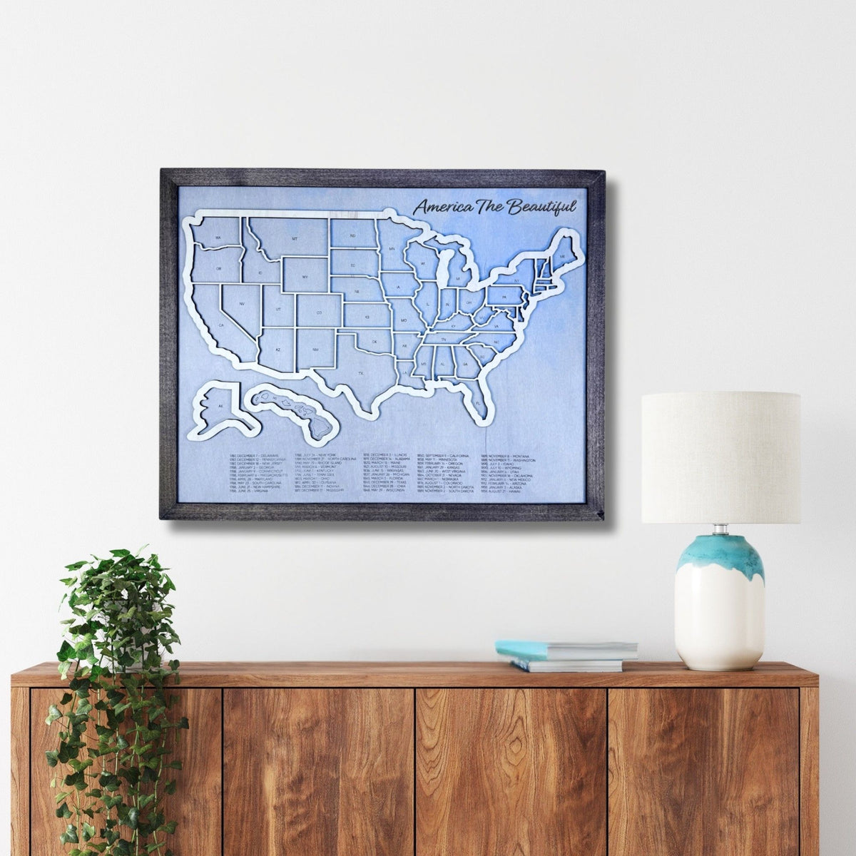 US Travel Map hanging on a wall above a wooden console.