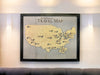Wooden NFL stadium travel map hanging on a wall over a couch. 