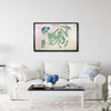 Living room with a white sofa, coffee table, and framed golf map of Augusta National Golf Club hanging on the wall. 