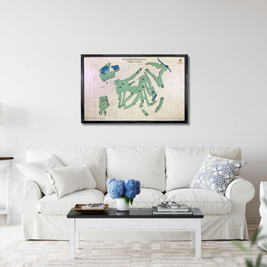Living room with a white sofa, coffee table, and framed golf map of Augusta National Golf Club hanging on the wall. 