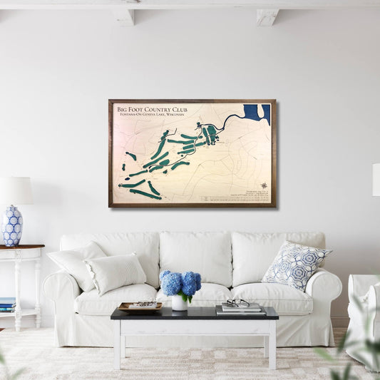 Living room with a framed map of Big Foot Country Club on the wall above a white sofa.