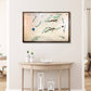 Framed wooden golf course map on a wall above a wooden table with decorative items.