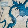 Close up view of a map showing engraved roads, icons, and the cut multi water layers. 