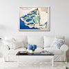 Framed wooden golf map of Coral Creek Club on a wall above a white sofa with decorative pillows.
