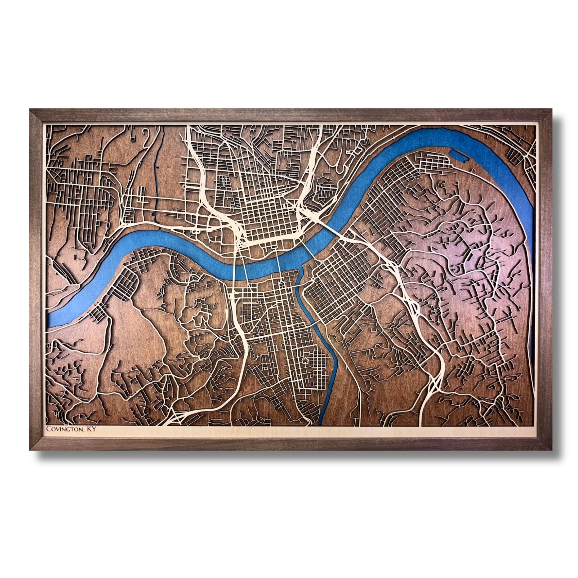 3D wooden map of Covington, KY with raised roads and blue water stain. 