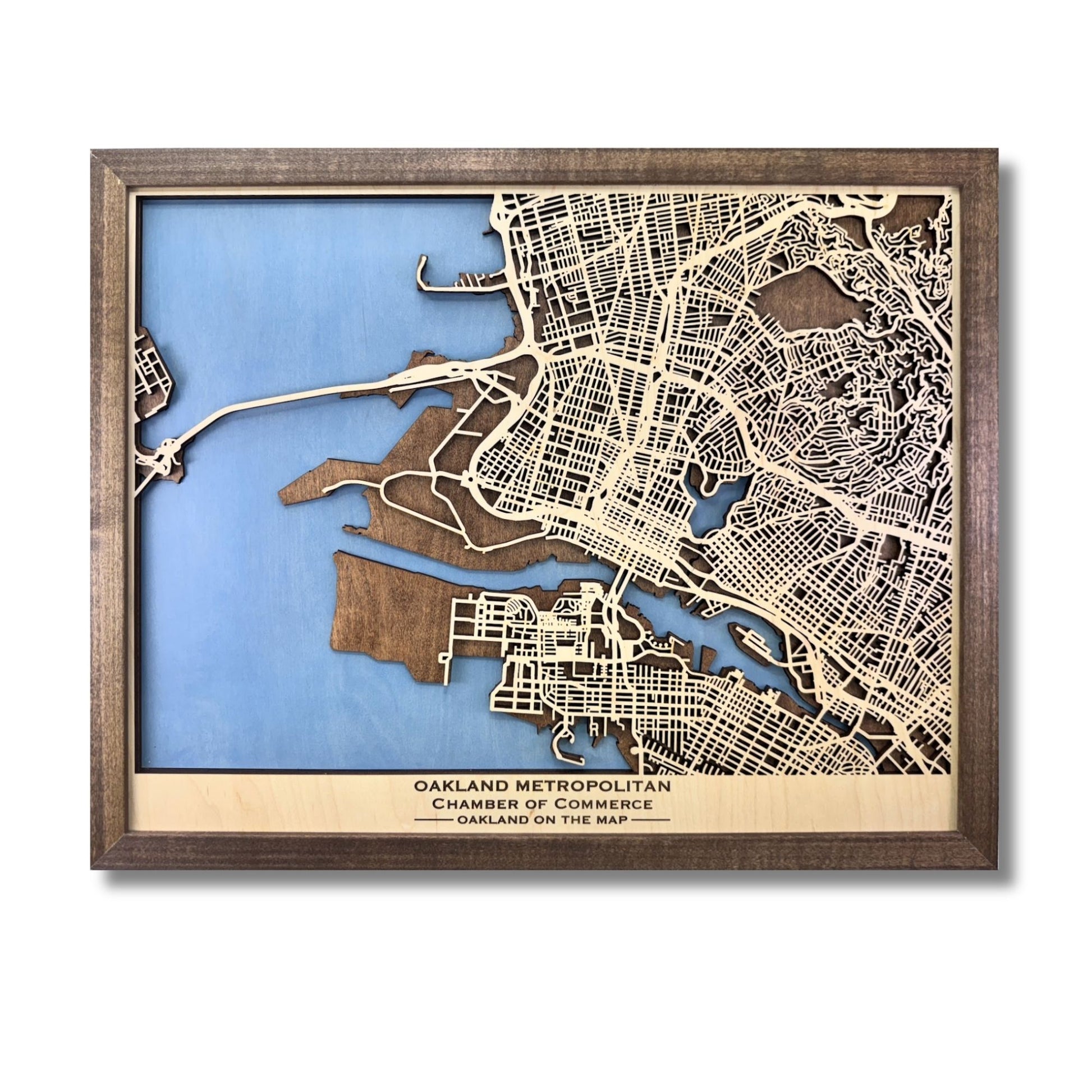 Custom city map showing light blue water stain, walnut brown frame, and personalized text. 