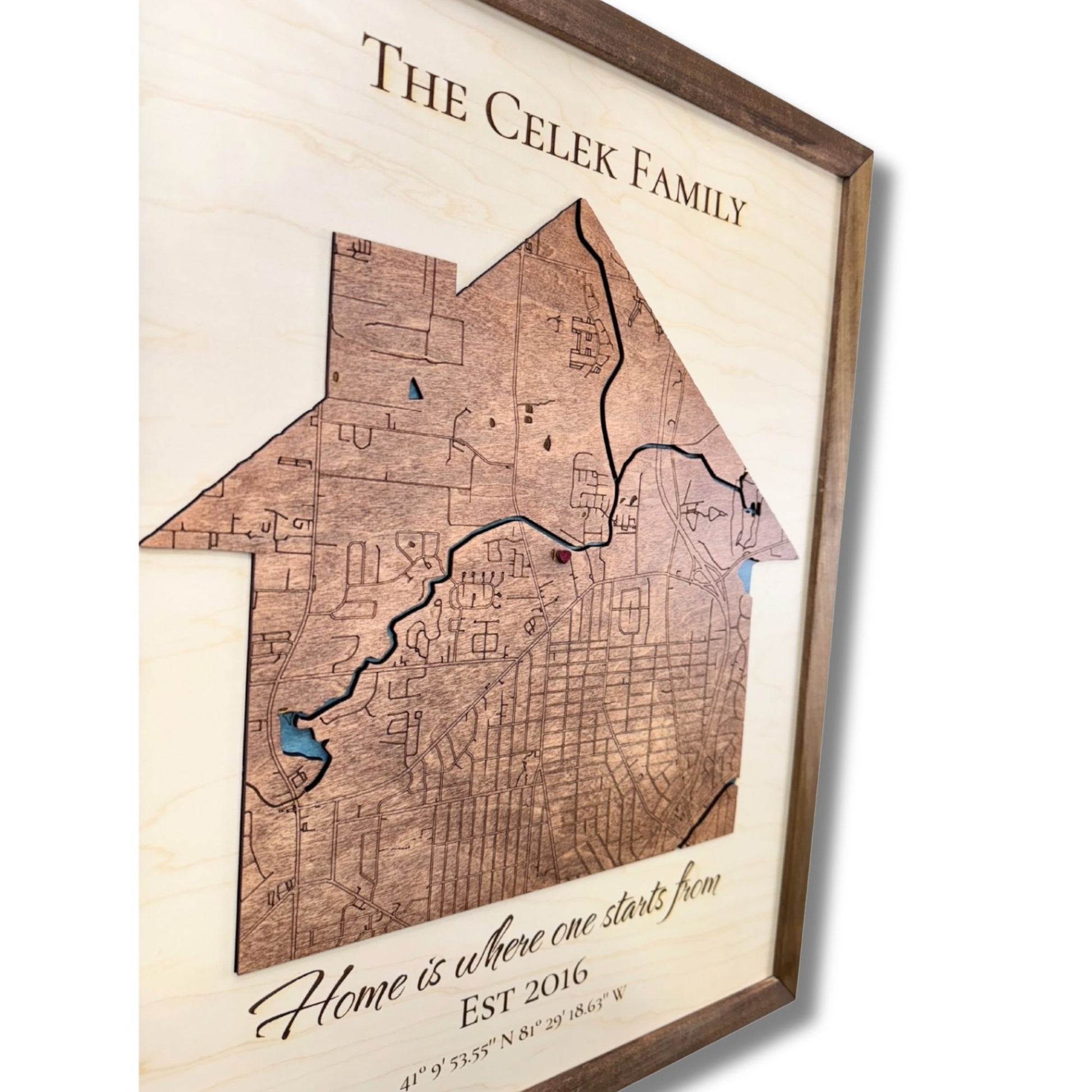 Sideview of a 3D wooden map shaped like a house with a raised red heart icon. 