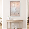 Framed topographic map on a wall above a wooden console table with decorative items.