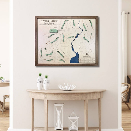 Framed wooden map of Devils Ridge Golf Club on a wall above a wooden table.