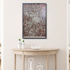 Wooden map of Durham, NC hanging on a wall above a wooden table containing decorative items. 